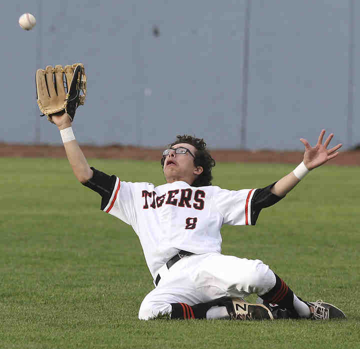 Massillon's Jaylen Leedy slides to make the catch on a ball hit by Fitch's Kole Klasic during the third inning of their Division I district semifinal game at Thurman Munson Memorial Stadium in Canton.  (Scott Heckel / The Canton Repository)